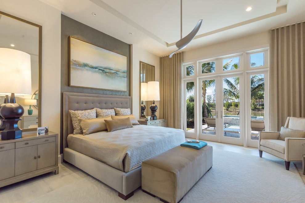 Inspiration for a traditional bedroom in Miami with beige walls, light hardwood flooring and beige floors.