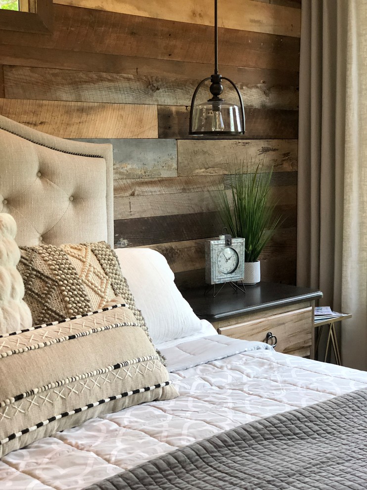 This is an example of a medium sized rustic master bedroom in Atlanta with grey walls, medium hardwood flooring and brown floors.