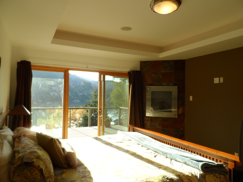 Example of a mid-sized classic master carpeted bedroom design in Seattle with brown walls, a corner fireplace and a stone fireplace