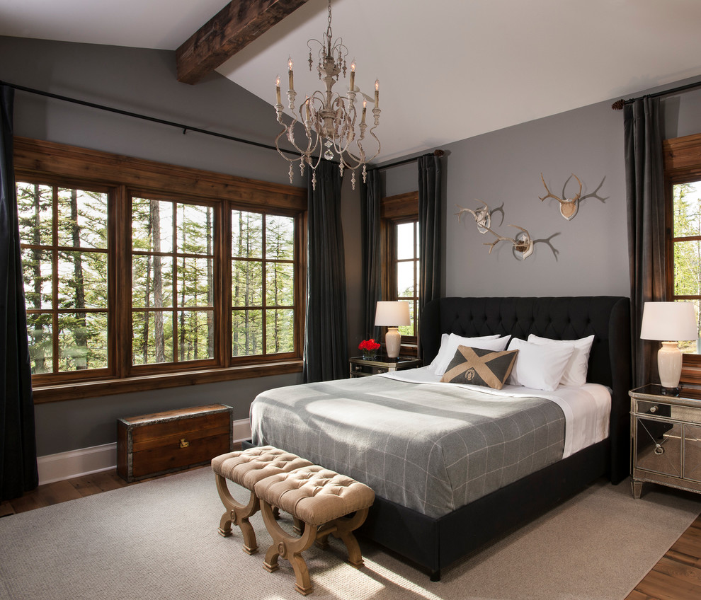 Photo of a large rustic master bedroom in Other with blue walls and medium hardwood flooring.
