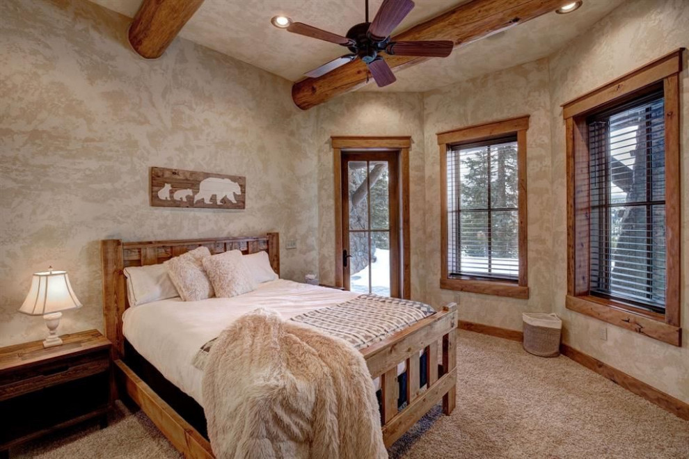Large mountain style guest light wood floor and beige floor bedroom photo in Other with white walls, a standard fireplace and a stone fireplace