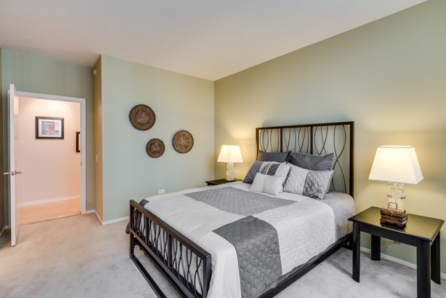 シカゴにある広いトランジショナルスタイルのおしゃれな客用寝室 (カーペット敷き、青い壁、暖炉なし、白い床)