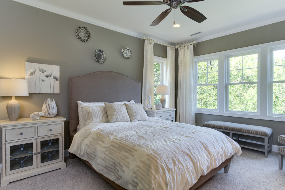 This is an example of a beach style master bedroom in Other with carpet and grey walls.