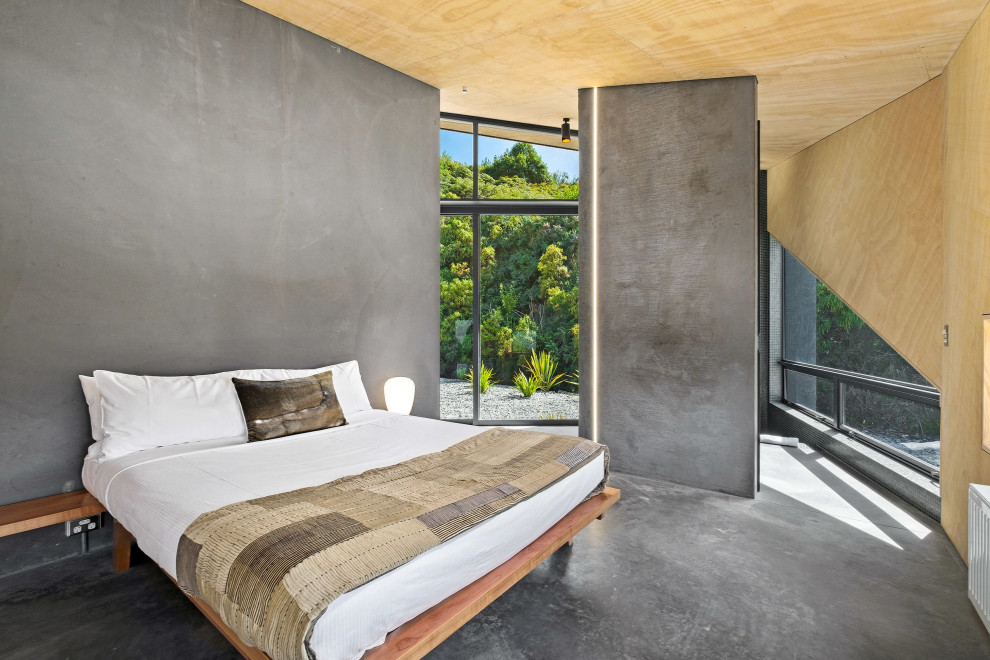 Foto di una piccola camera matrimoniale minimalista con pavimento in cemento, pavimento grigio, soffitto in legno, pareti grigie e pareti in legno