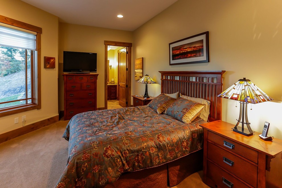 This is an example of a large classic guest bedroom in Orlando with yellow walls, carpet and no fireplace.