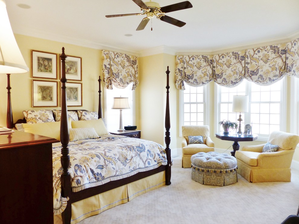 Inspiration for a large traditional master bedroom in Columbus with yellow walls and carpet.