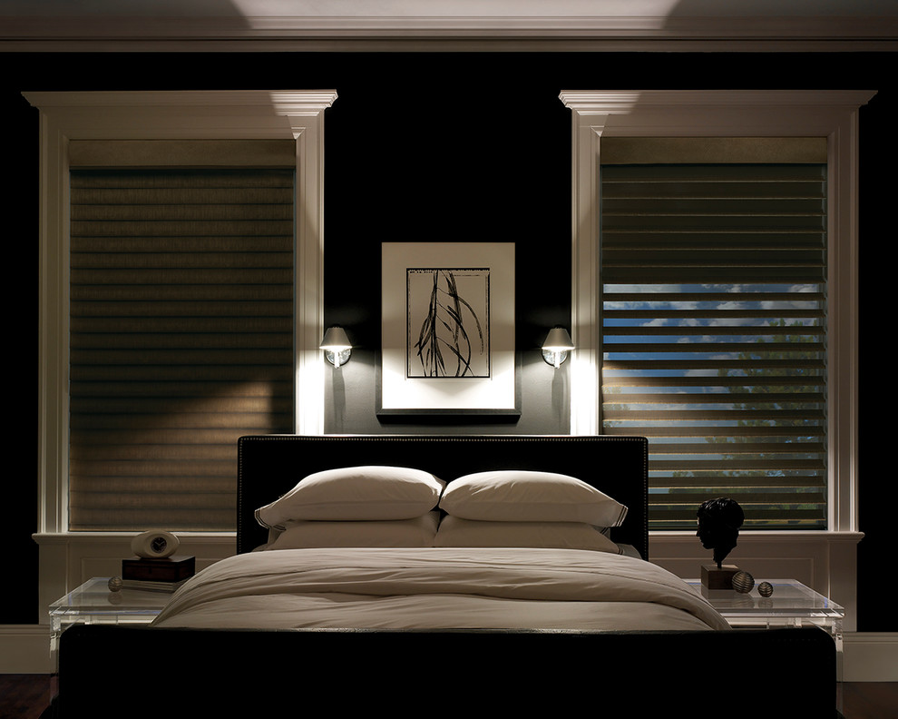 Example of a mid-sized trendy master medium tone wood floor bedroom design in Indianapolis with black walls