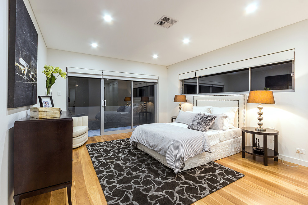 Design ideas for a contemporary grey and brown and grey and silver bedroom in Hobart with white walls, light hardwood flooring and no fireplace.