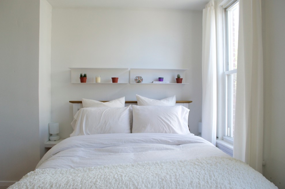 Modelo de dormitorio principal bohemio pequeño sin chimenea con paredes blancas y suelo de madera en tonos medios