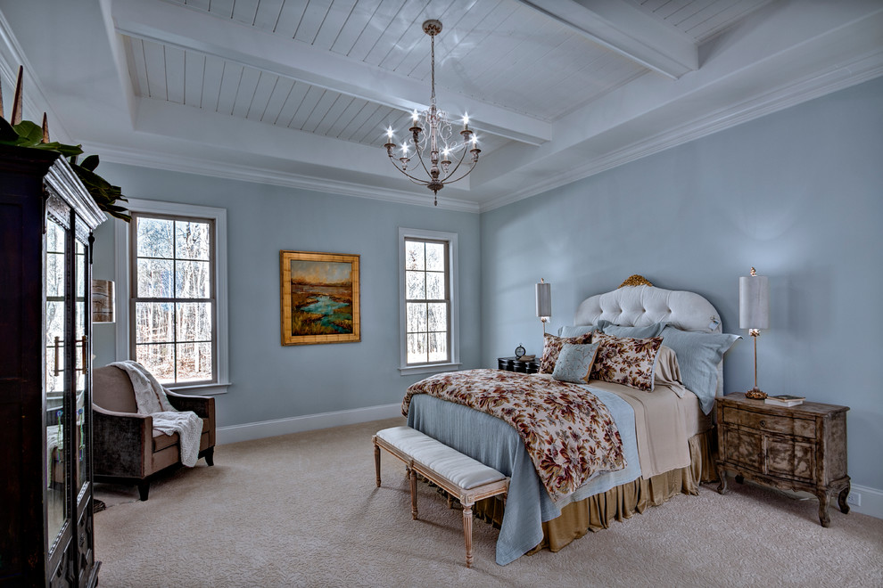 Cette image montre une grande chambre traditionnelle avec un mur bleu, aucune cheminée et un sol beige.