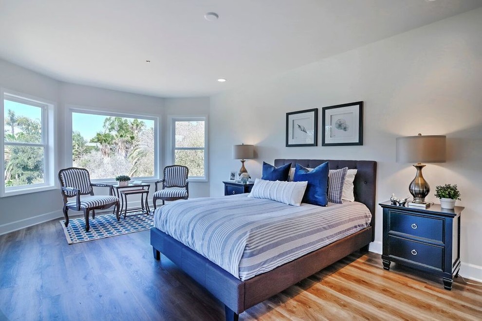 Large traditional master bedroom in Orange County with grey walls, medium hardwood flooring, no fireplace and brown floors.