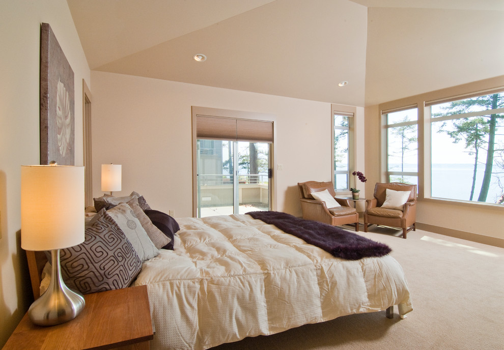 This is an example of a traditional master bedroom in Seattle with white walls and carpet.