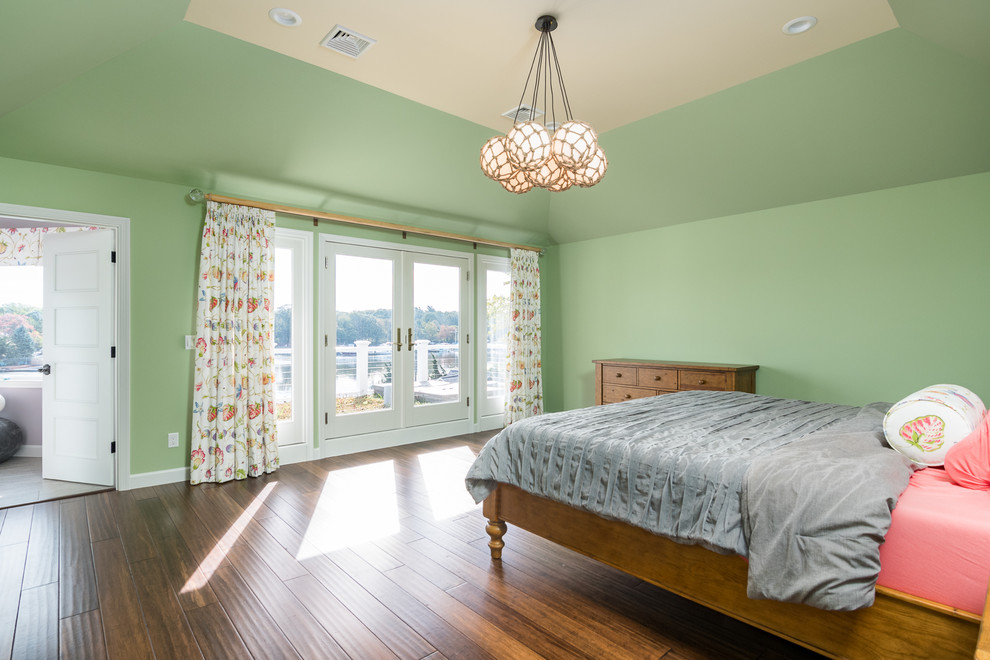 This is an example of a large traditional master bedroom in New York with green walls, bamboo flooring and brown floors.