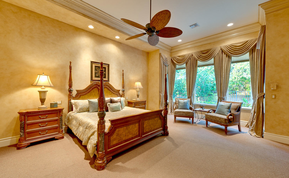 Example of a classic carpeted bedroom design in Miami with beige walls