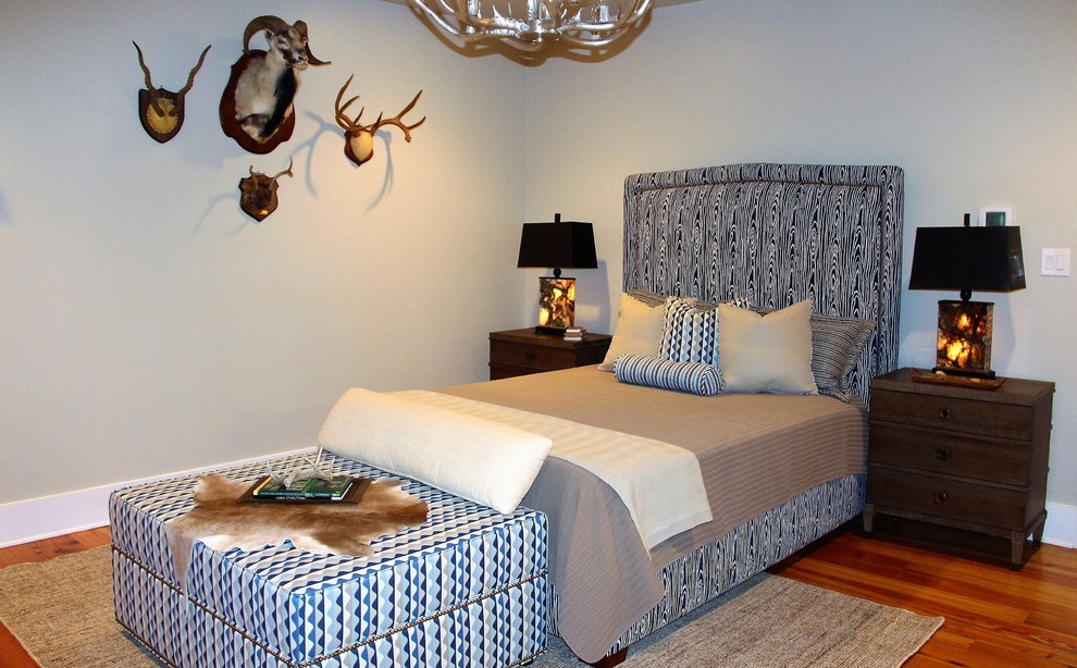 Medium sized rustic bedroom in Miami with beige walls and light hardwood flooring.