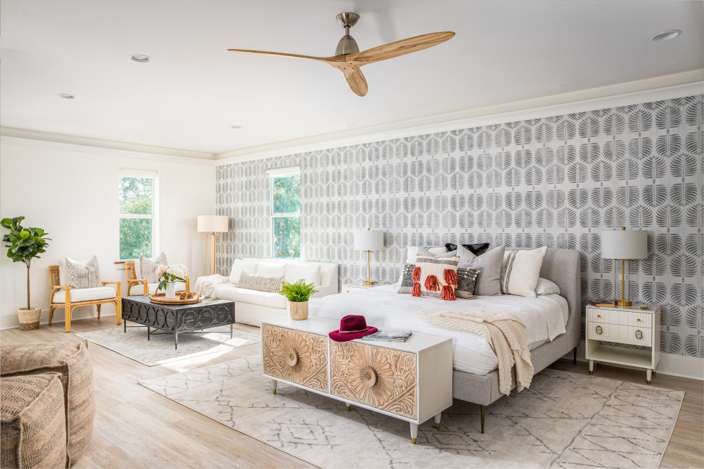 Coastal bedroom in Charleston with grey walls, light hardwood flooring, beige floors and wallpapered walls.