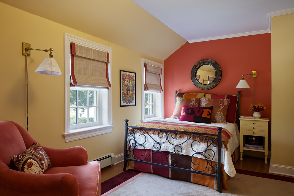 Photo of a medium sized classic guest bedroom in New York with red walls, light hardwood flooring, no fireplace, beige floors and feature lighting.