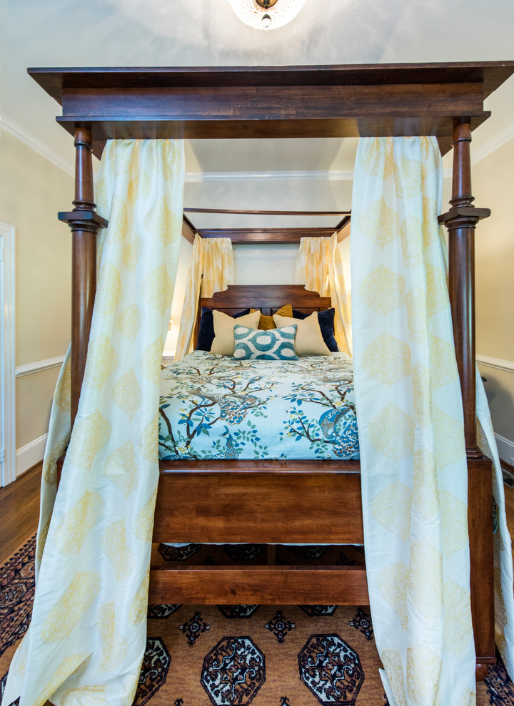 Photo of a medium sized classic guest bedroom in Raleigh with beige walls and medium hardwood flooring.
