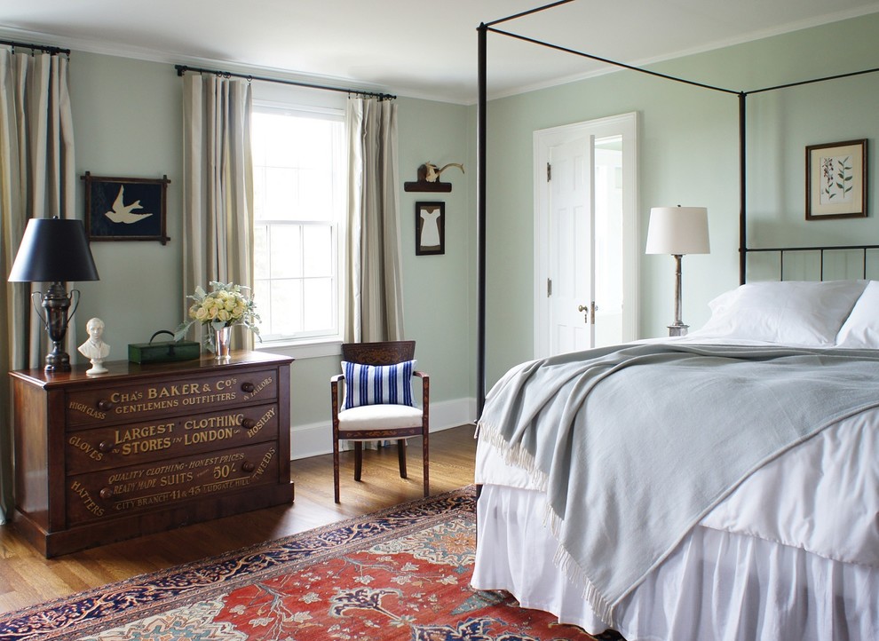 Inspiration for a mid-sized timeless master medium tone wood floor bedroom remodel in New York with green walls and no fireplace