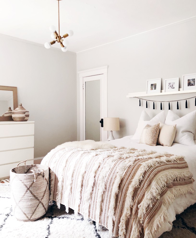 Example of a mid-sized transitional master medium tone wood floor bedroom design in Boston with gray walls