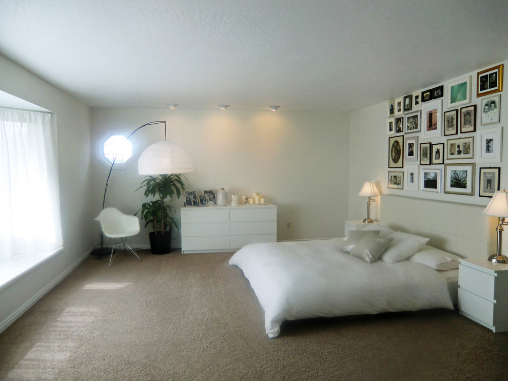 Large modern master bedroom in London with white walls, carpet and no fireplace.