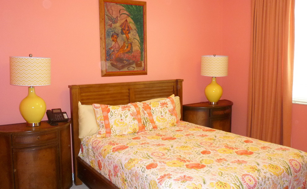 Large bohemian guest bedroom in Miami with pink walls, carpet and no fireplace.
