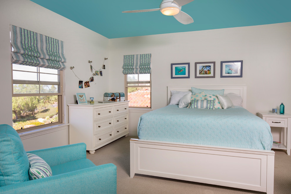 Example of a mid-sized beach style guest carpeted bedroom design in San Diego with white walls and no fireplace