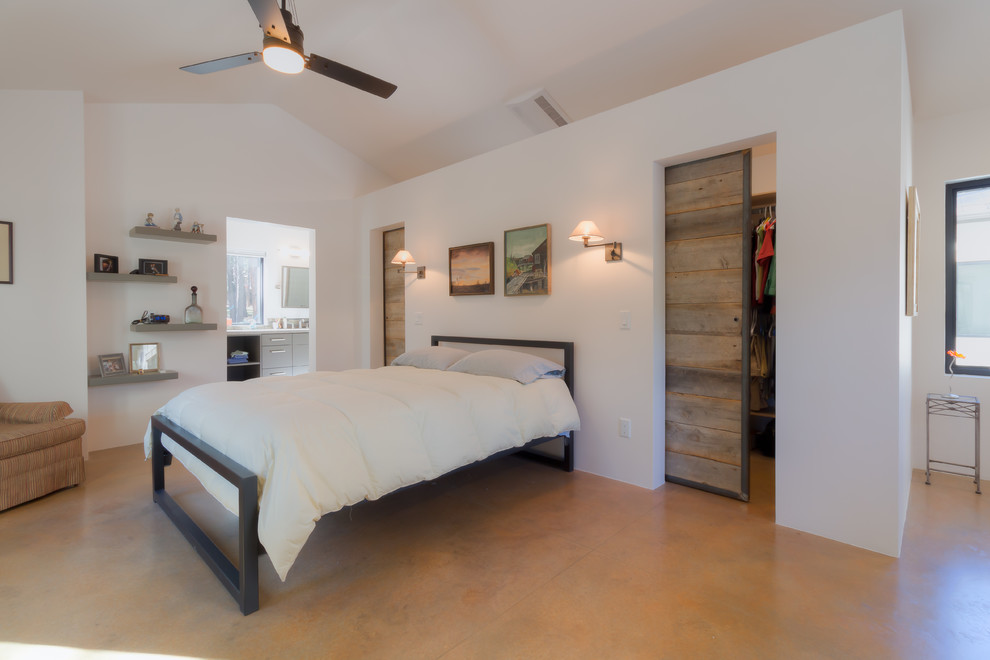 Example of a large transitional master concrete floor bedroom design in Phoenix with white walls