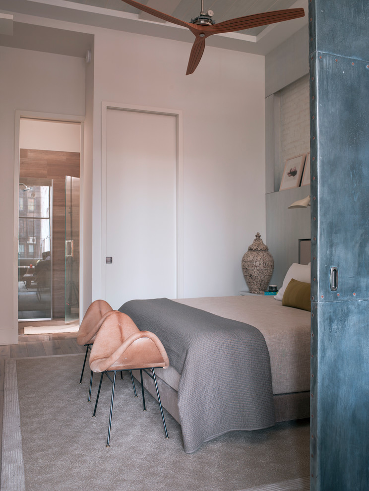 This is an example of a contemporary grey and pink bedroom in New York.
