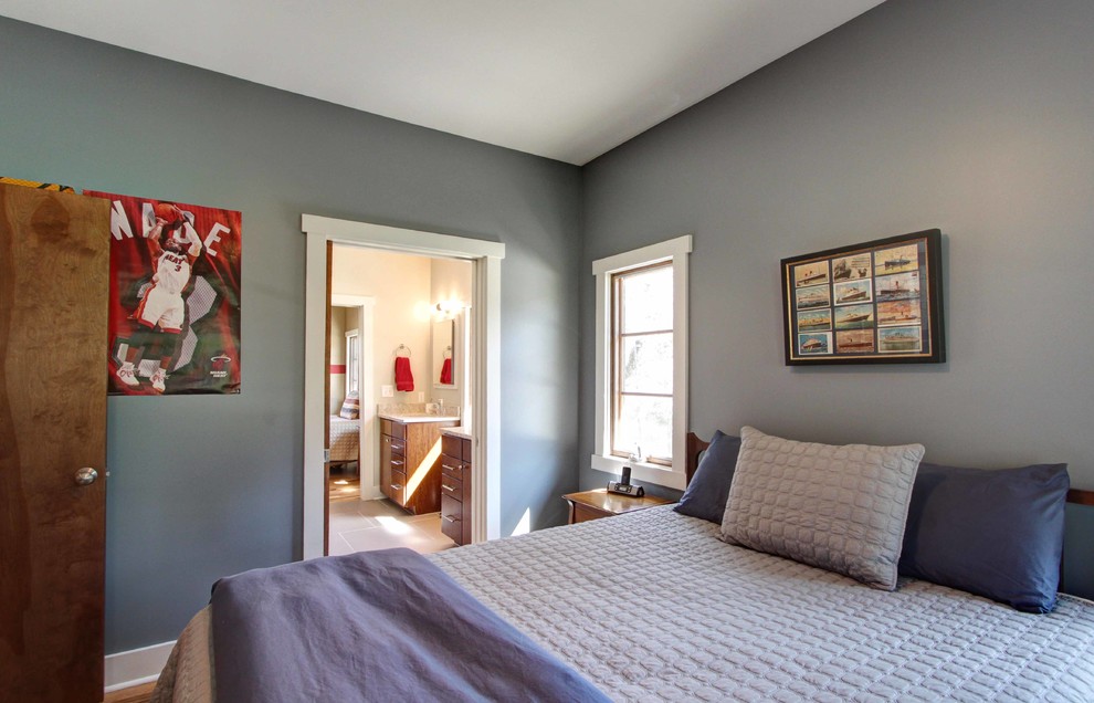 Bedroom - contemporary guest medium tone wood floor bedroom idea in Other