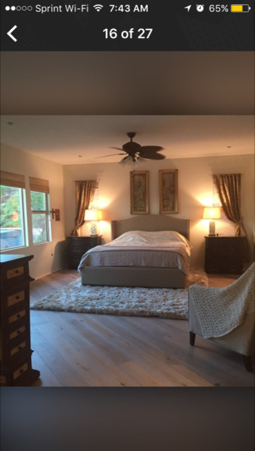 Large vintage master bedroom in San Diego with beige walls, light hardwood flooring, no fireplace and beige floors.