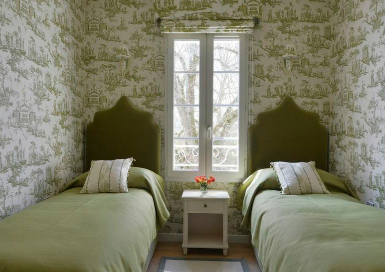 Photo of a small mediterranean guest bedroom in Other with green walls.