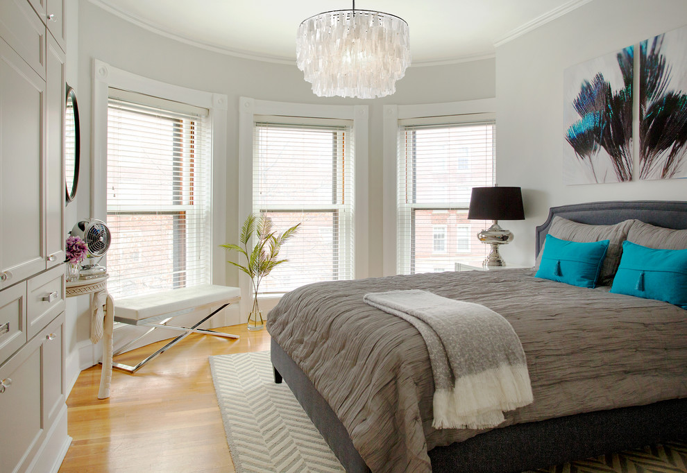 Inspiration for a transitional medium tone wood floor bedroom remodel in Boston with gray walls