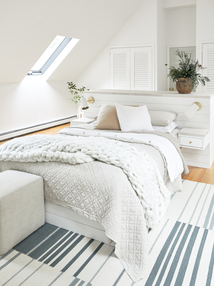 Design ideas for a large nautical master bedroom in Boston with white walls, light hardwood flooring and brown floors.