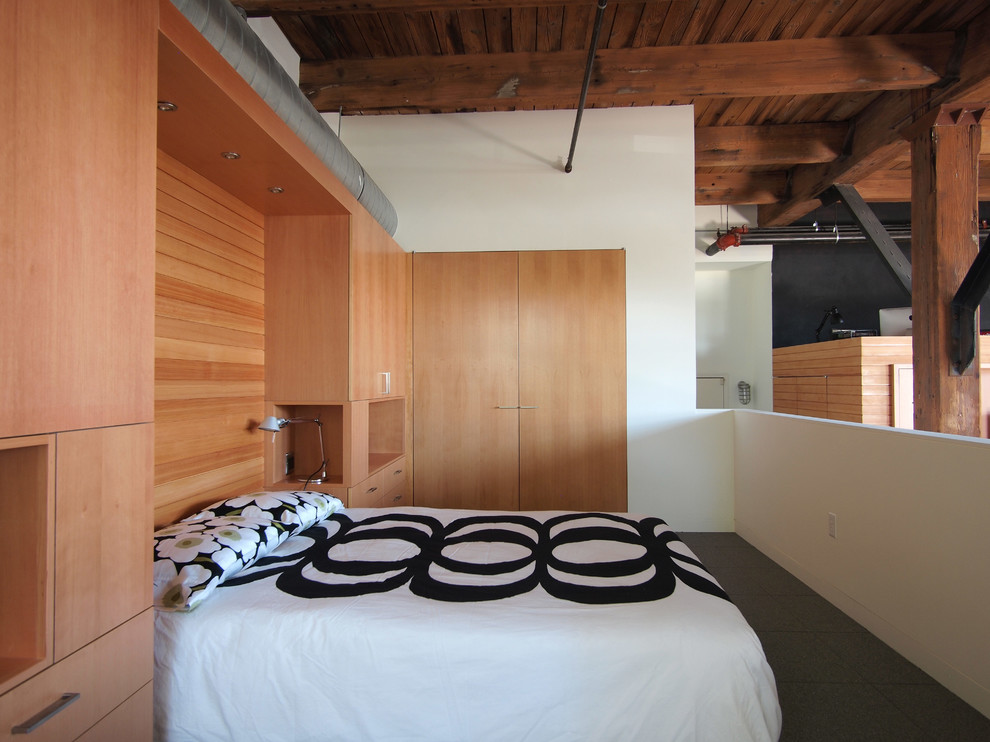Inspiration for an industrial mezzanine bedroom in New York with white walls.