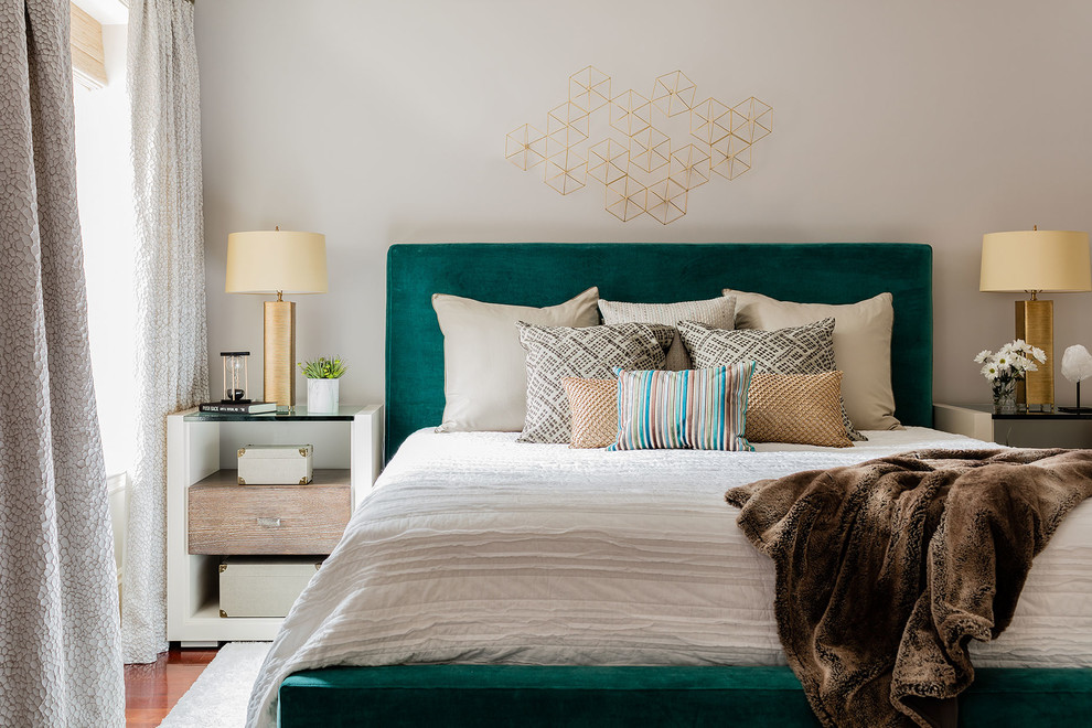 Mid-sized trendy master medium tone wood floor bedroom photo in Boston with gray walls and no fireplace