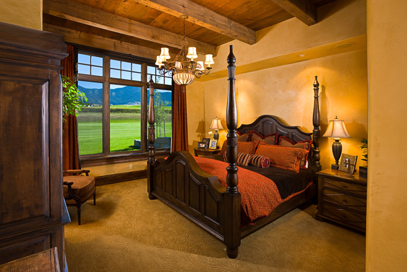 Inspiration for a rustic master bedroom in Other with beige walls and carpet.