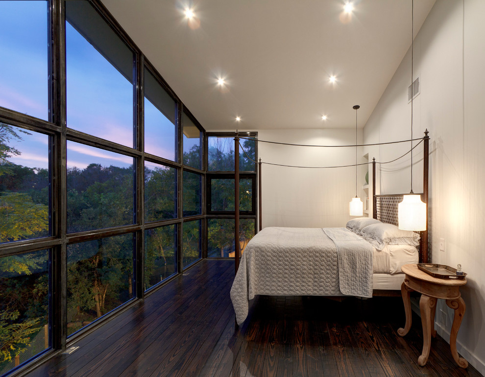 Design ideas for a large contemporary master bedroom in Austin with white walls and dark hardwood flooring.