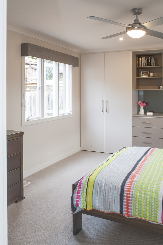 Photo of a medium sized contemporary master bedroom in Melbourne with beige walls and carpet.
