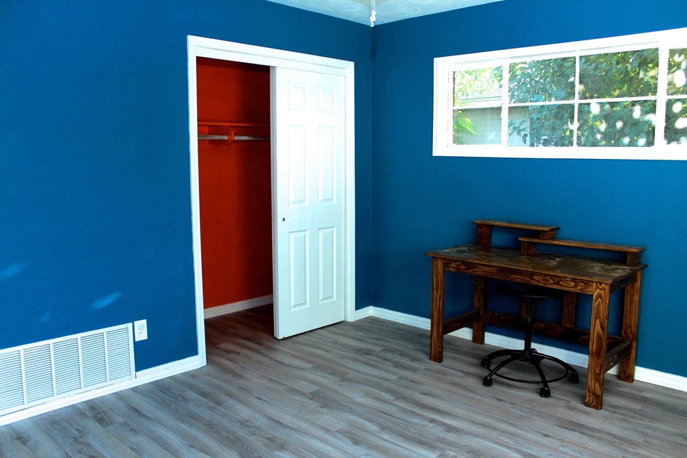 Eclectic light wood floor bedroom photo in Portland with blue walls