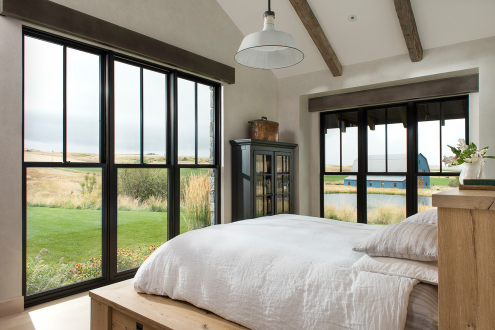 Imagen de dormitorio principal campestre grande con paredes beige y suelo de madera clara