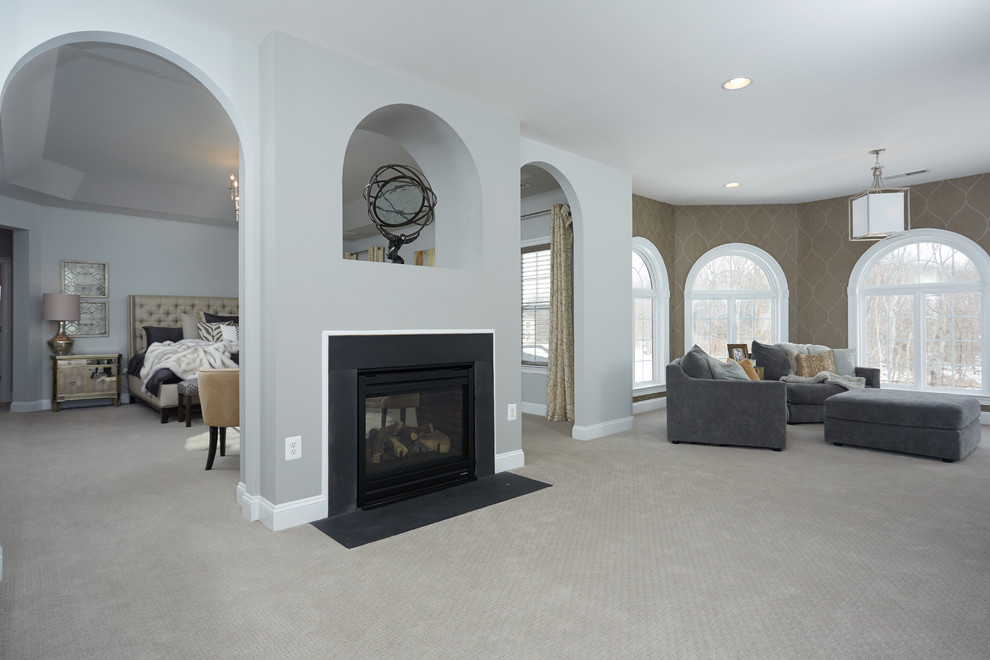 Large transitional master carpeted bedroom photo in DC Metro with gray walls, a two-sided fireplace and a metal fireplace