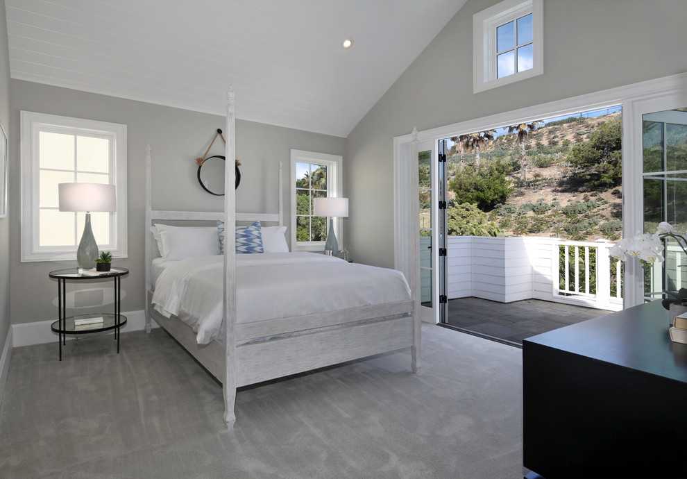 Design ideas for a beach style guest bedroom in Orange County with grey walls and carpet.
