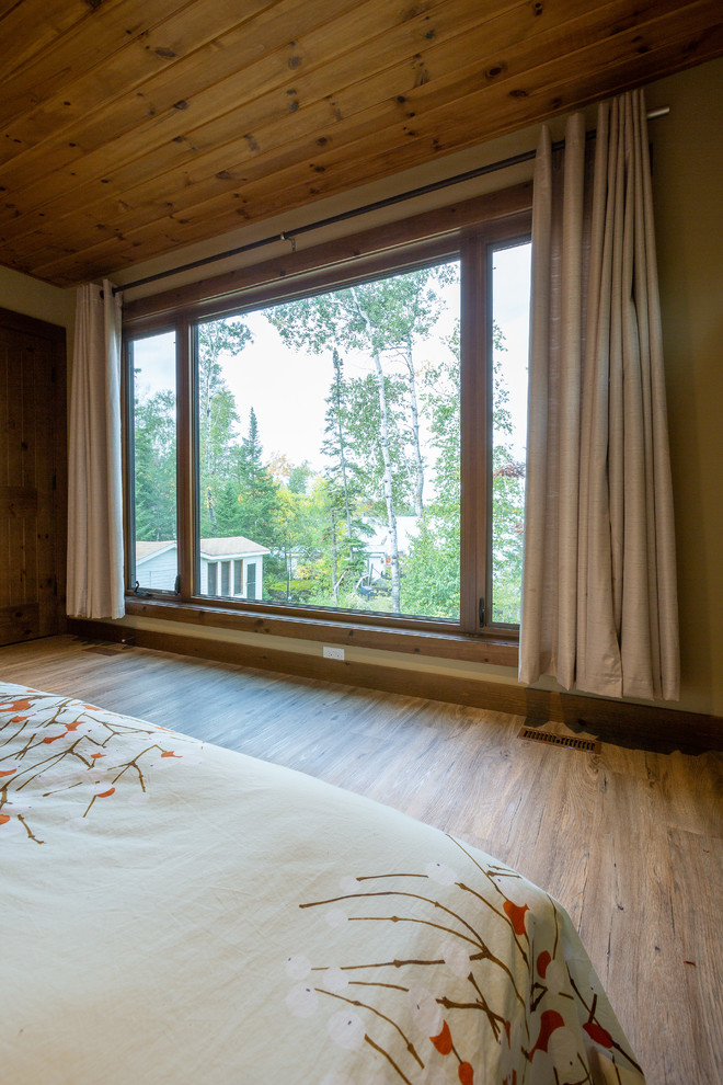Diseño de habitación de invitados costera grande con paredes beige, suelo de linóleo y suelo marrón