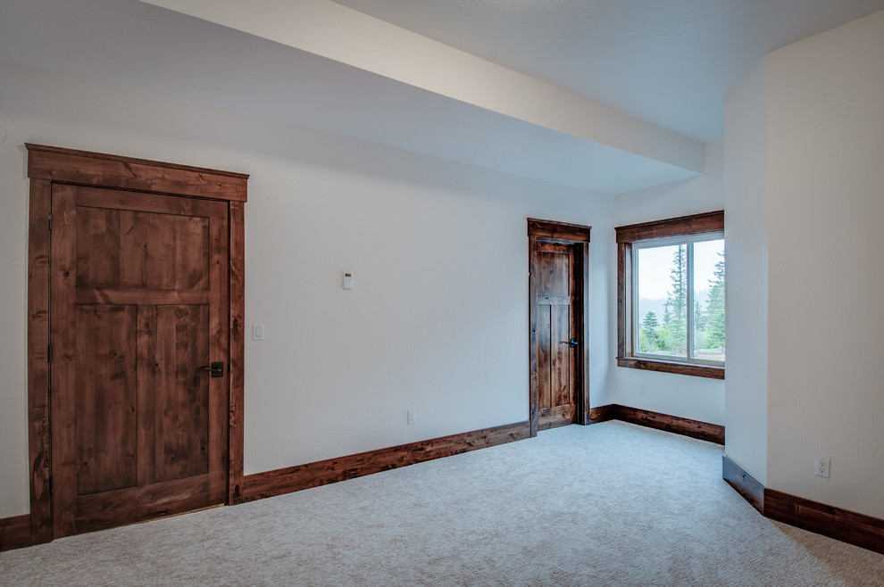 Medium sized rustic guest bedroom in Seattle with white walls, carpet and no fireplace.
