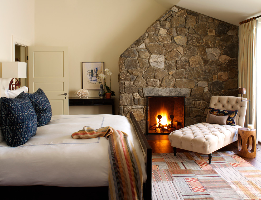 Bedroom - traditional bedroom idea in New York with beige walls, a standard fireplace and a stone fireplace