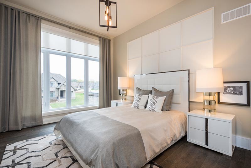Inspiration for a medium sized traditional guest bedroom in Toronto with beige walls and dark hardwood flooring.