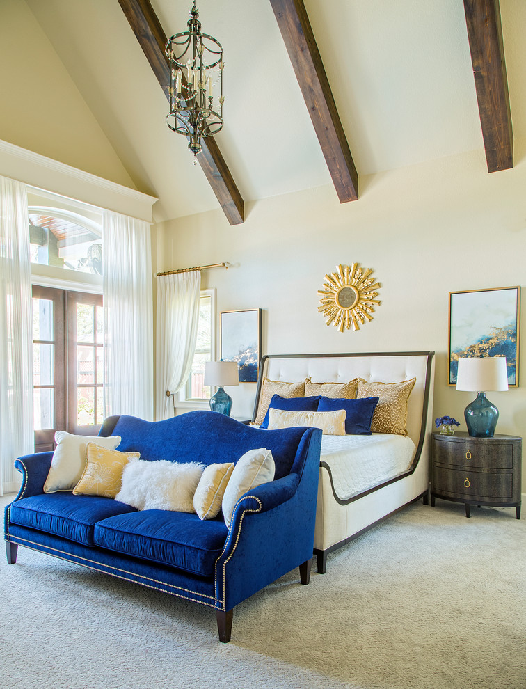 Small tuscan master carpeted and beige floor bedroom photo in Other with beige walls