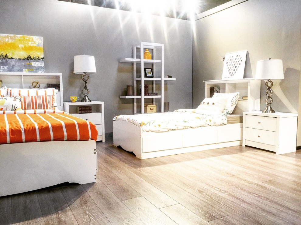 Inspiration for a large world-inspired mezzanine bedroom in Vancouver with white walls and laminate floors.
