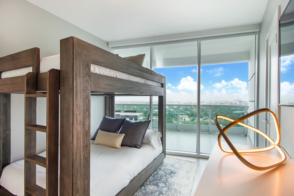 This is an example of a medium sized contemporary bedroom in Miami with grey walls and grey floors.